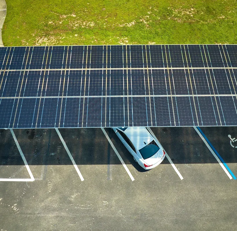 Aerial view of a single row solar carport above a row of parking spaces